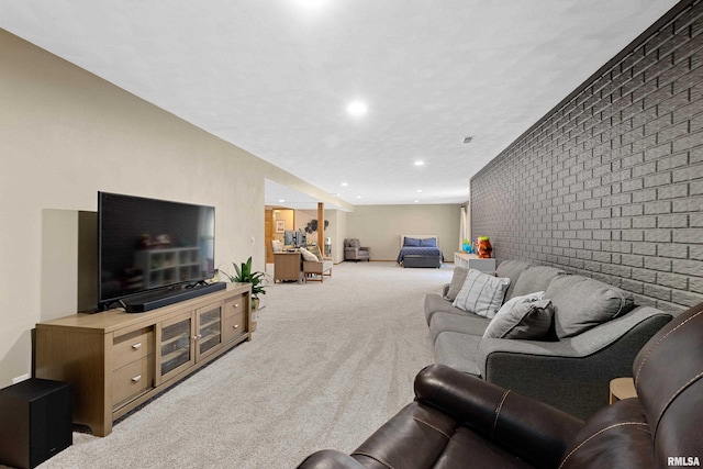 carpeted living area featuring an accent wall, recessed lighting, and brick wall