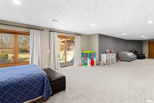 carpeted bedroom with recessed lighting, visible vents, and access to exterior