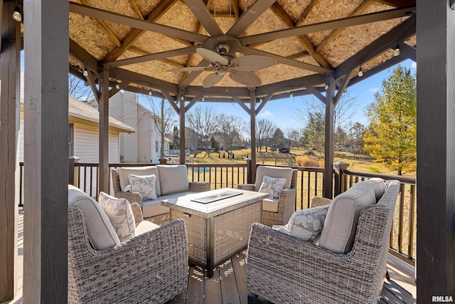 deck with a gazebo, a ceiling fan, and an outdoor hangout area