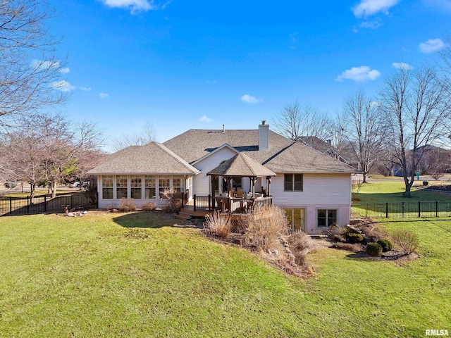 rear view of property featuring a yard, a fenced backyard, and a wooden deck