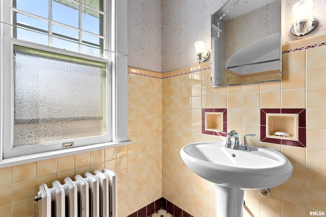 bathroom with radiator and tile walls