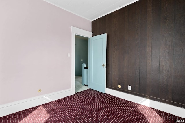 unfurnished room with carpet floors and crown molding