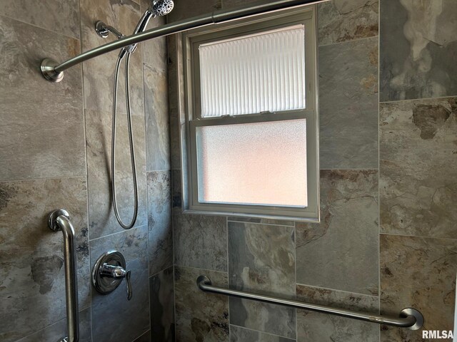 full bathroom with tiled shower