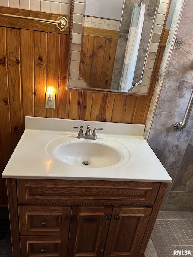 full bathroom with a shower with curtain, wood walls, and vanity