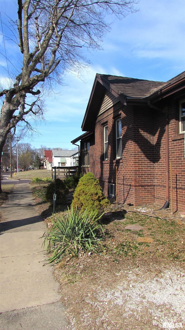 view of property exterior with brick siding