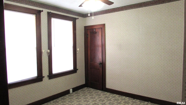 spare room with tile patterned floors, baseboards, and wallpapered walls