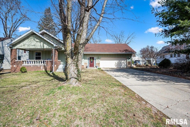 view of front of home featuring covered porch, concrete driveway, a front lawn, a garage, and brick siding