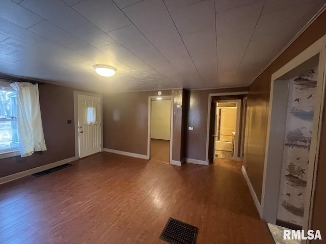 foyer entrance with visible vents, baseboards, and wood finished floors