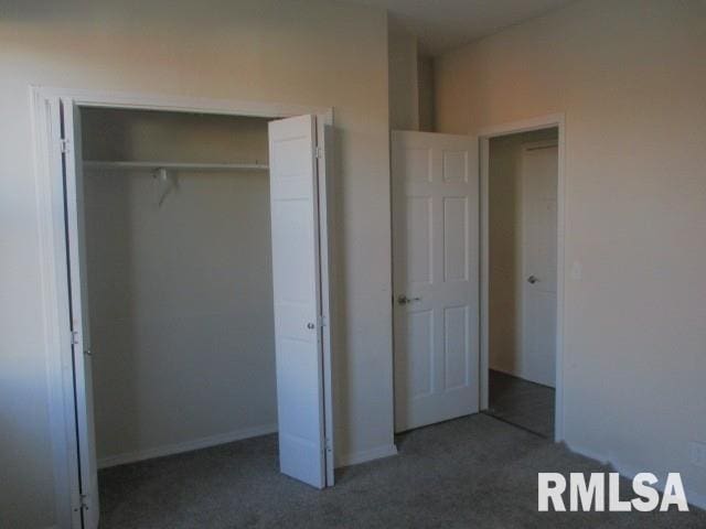 unfurnished bedroom featuring a closet and carpet