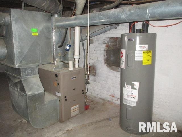 utility room featuring heating unit and electric water heater