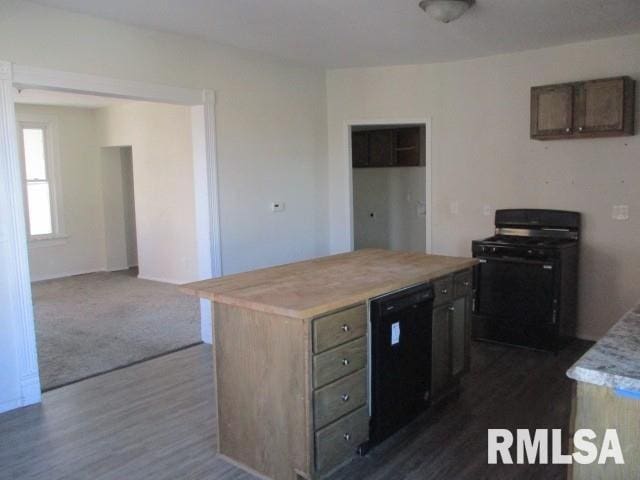 kitchen featuring a center island, range with gas cooktop, dark wood-type flooring, dishwasher, and light countertops