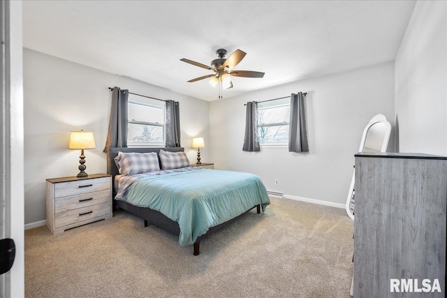 bedroom with light colored carpet, baseboards, and ceiling fan