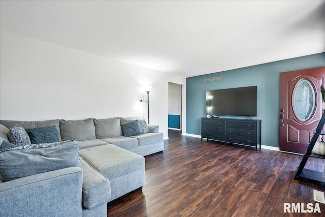 living area with baseboards and wood finished floors