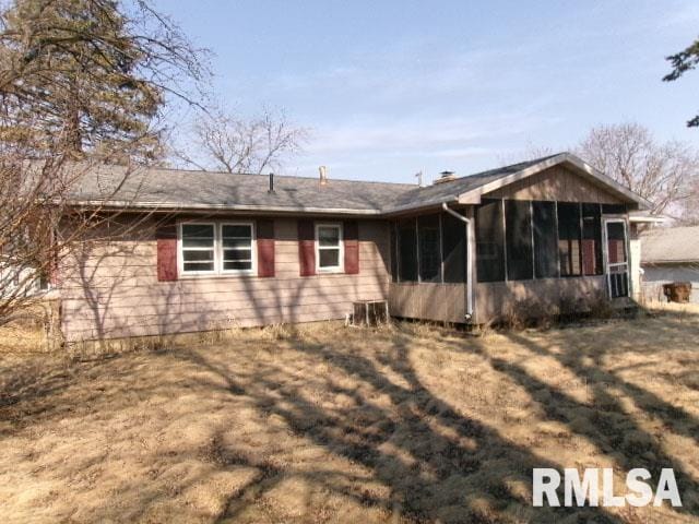 rear view of property with a sunroom