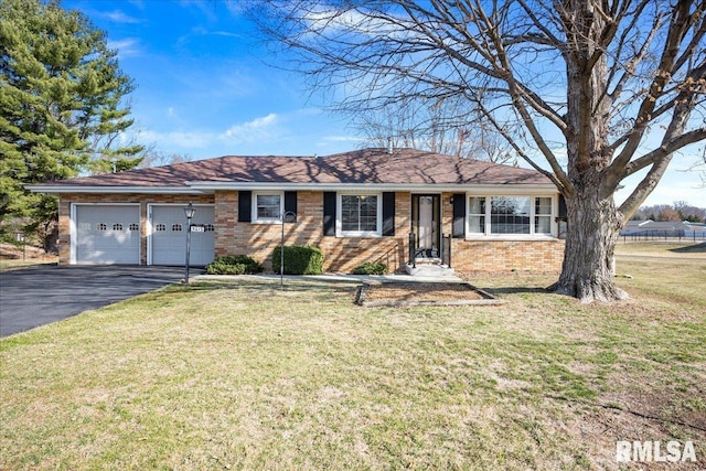 ranch-style house featuring brick siding, driveway, a front yard, and a garage