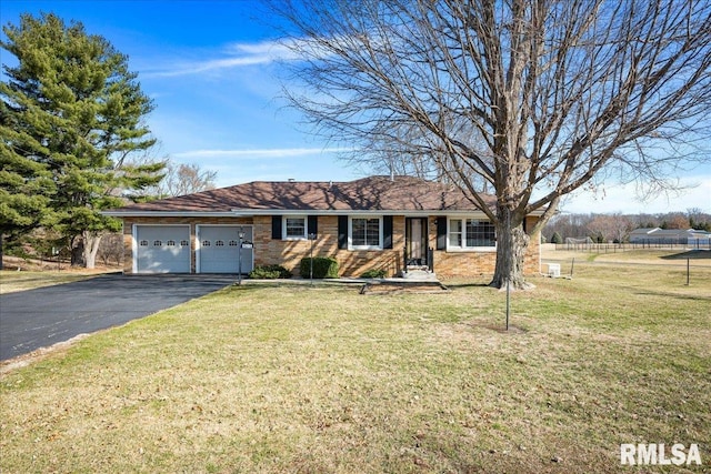 single story home featuring aphalt driveway, an attached garage, a front lawn, and fence