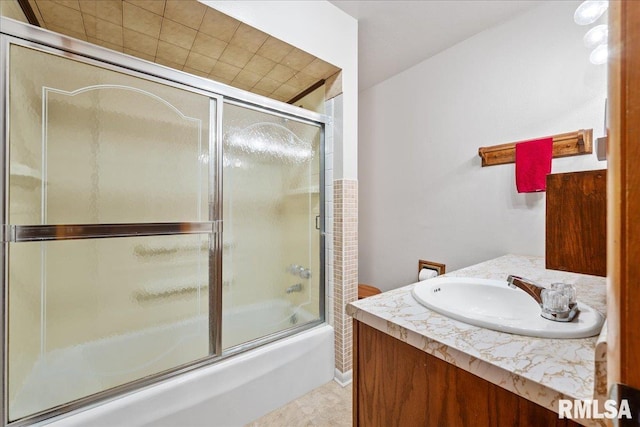 full bath featuring combined bath / shower with glass door and vanity