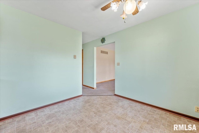 spare room with visible vents, baseboards, and a ceiling fan