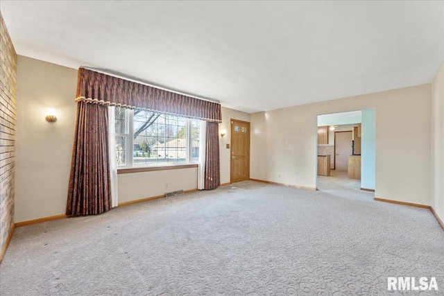 interior space with baseboards, visible vents, and light carpet