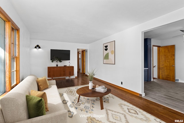 living area with visible vents and wood finished floors