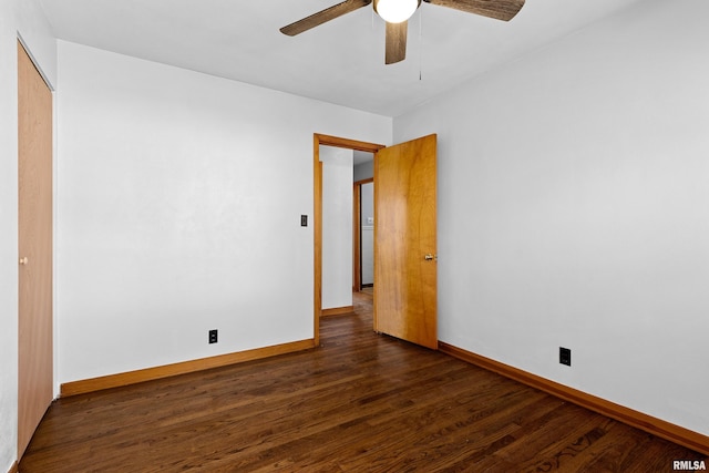 interior space featuring dark wood-style floors, a ceiling fan, and baseboards