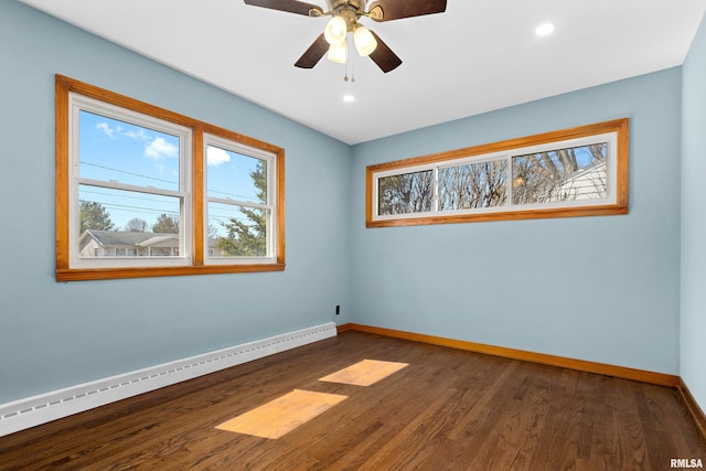 spare room featuring dark wood-type flooring, baseboards, baseboard heating, recessed lighting, and a ceiling fan