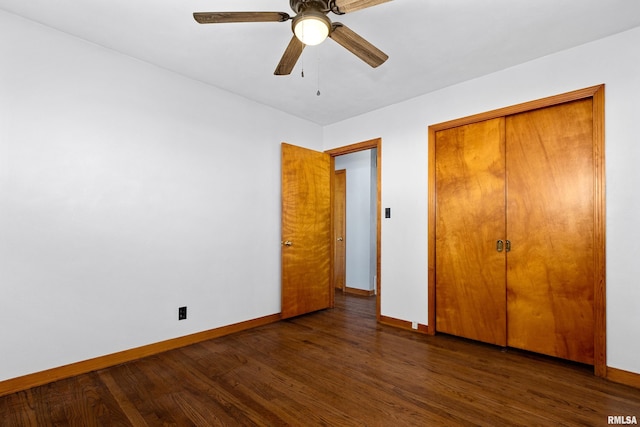 unfurnished bedroom with wood finished floors, baseboards, and a closet