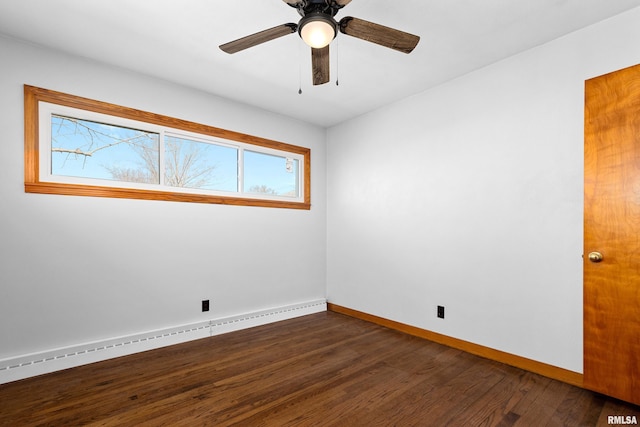 spare room featuring baseboards, dark wood-type flooring, baseboard heating, and ceiling fan