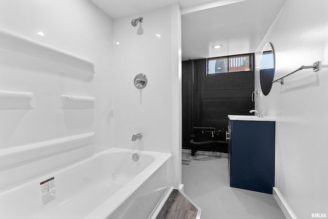 bathroom featuring vanity, concrete floors, and shower / bathtub combination