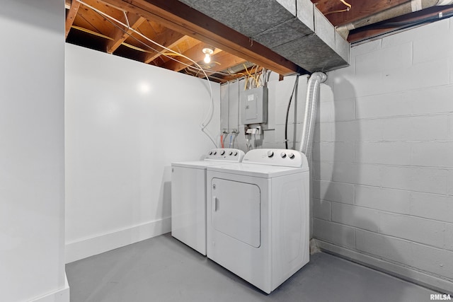 clothes washing area featuring electric panel, separate washer and dryer, and laundry area