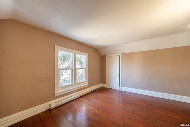 unfurnished room with dark wood finished floors, baseboards, and vaulted ceiling