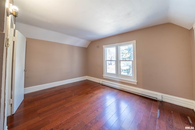 bonus room with a baseboard heating unit, lofted ceiling, dark wood-style floors, and baseboards