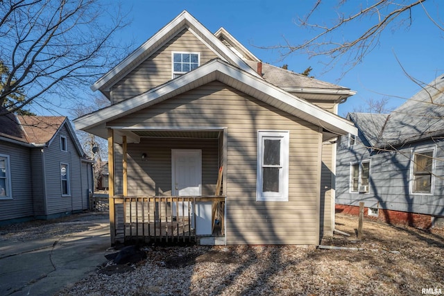 back of property with a porch