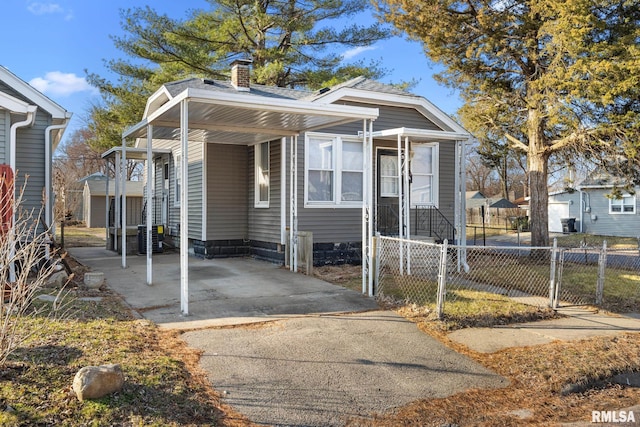 view of front of property featuring a gate, fence, driveway, a chimney, and entry steps