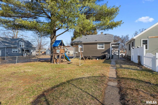 view of yard with a residential view, a playground, and a fenced backyard