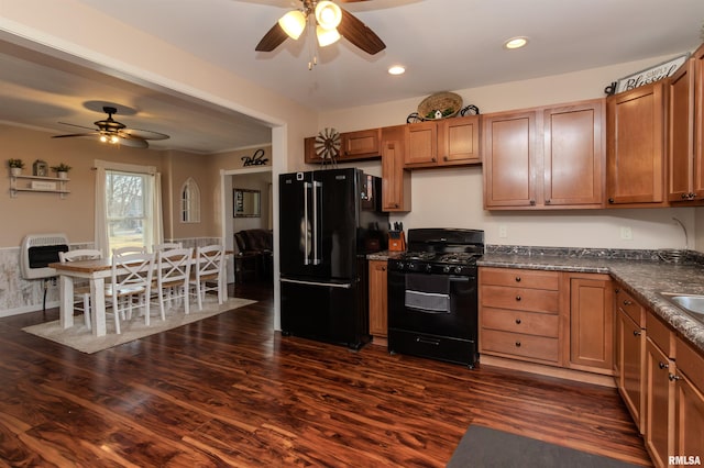 kitchen with brown cabinets, black appliances, and ceiling fan