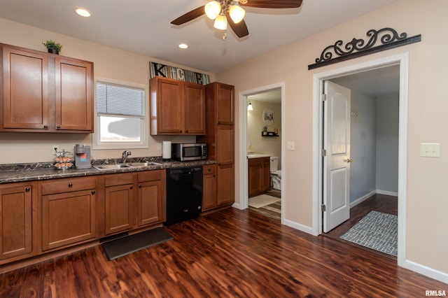 kitchen featuring dark wood-type flooring, a ceiling fan, a sink, stainless steel microwave, and black dishwasher