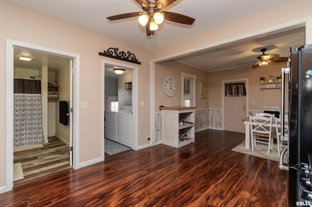 living room featuring wood finished floors, independent washer and dryer, and ceiling fan