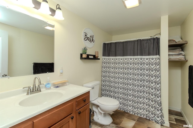 bathroom with toilet, vanity, and a shower with curtain