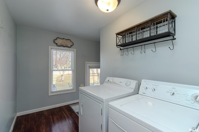 clothes washing area with laundry area, dark wood-style floors, baseboards, and washer and clothes dryer