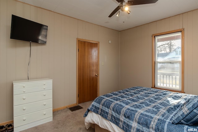 bedroom with a ceiling fan and carpet