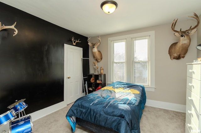 carpeted bedroom featuring baseboards