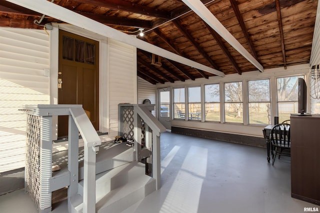 interior space with plenty of natural light, wooden ceiling, and lofted ceiling with beams