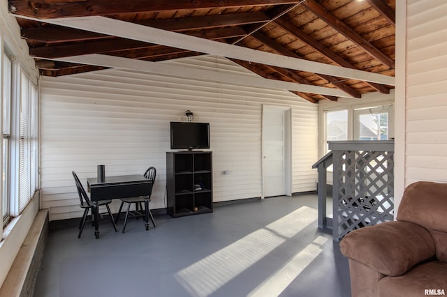 sunroom featuring lofted ceiling with beams and wooden ceiling