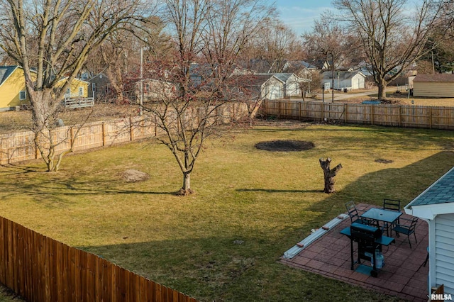 view of yard with a patio area, a residential view, and a fenced backyard