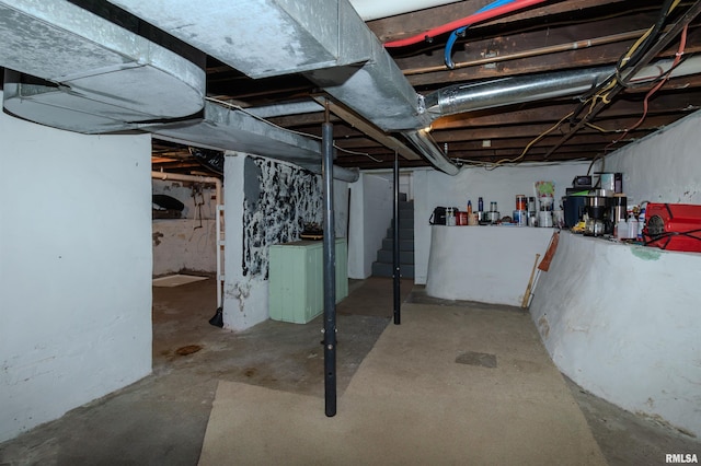 unfinished basement featuring stairway