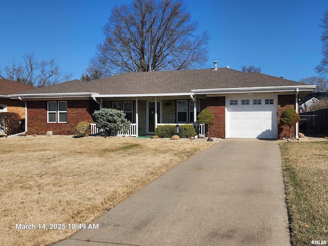 ranch-style home with brick siding, an attached garage, and a front yard