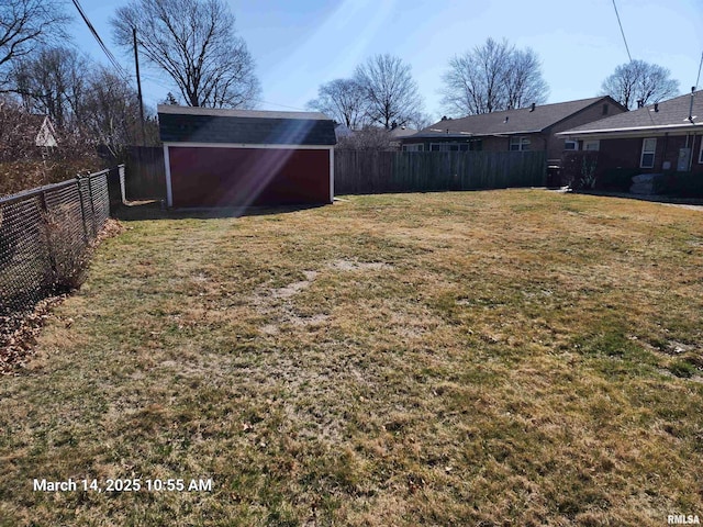 view of yard featuring an outdoor structure and a fenced backyard