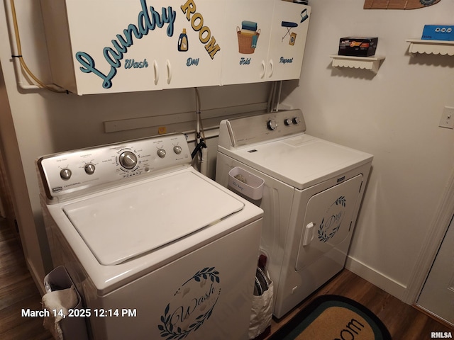 clothes washing area featuring dark wood-style floors, cabinet space, baseboards, and washing machine and clothes dryer