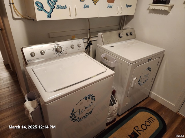 laundry room with baseboards, cabinet space, washing machine and dryer, and dark wood-style flooring